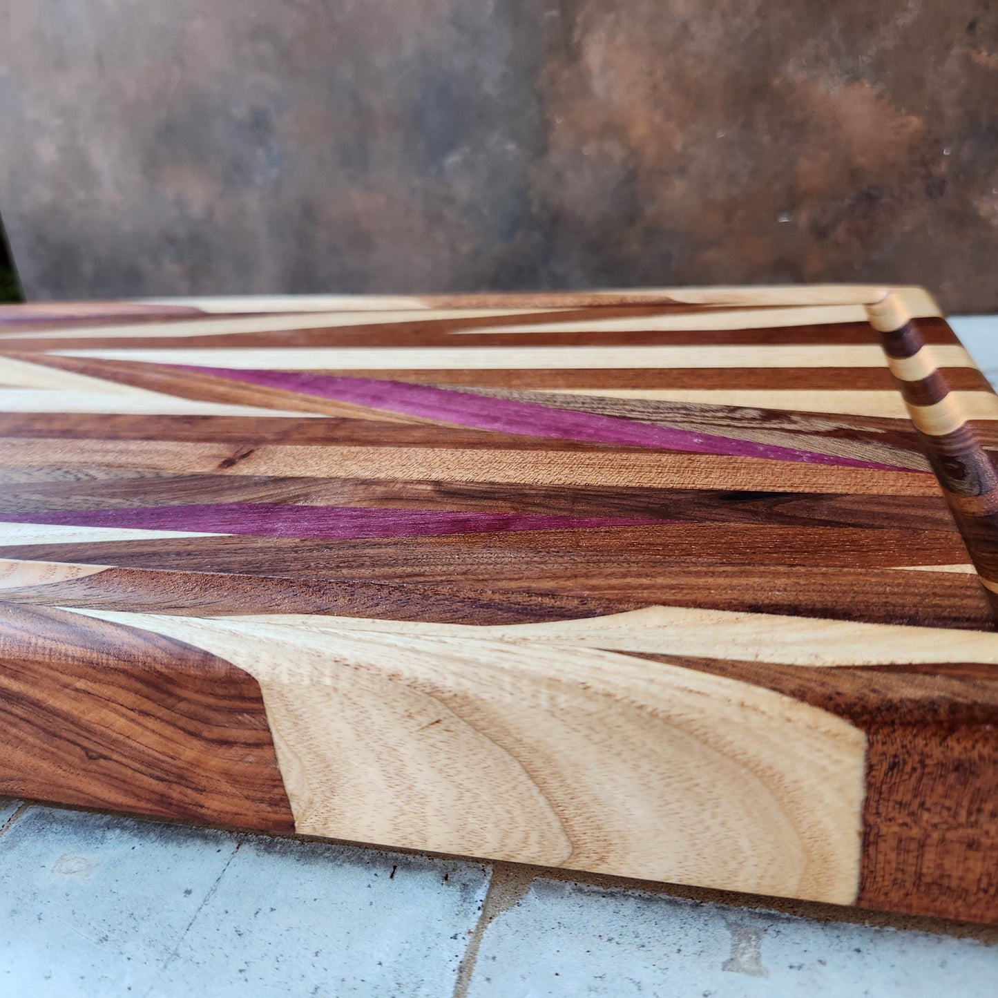 Cutting Board in Purple Heart, Padauk, Black Walnut, Sapele, and Mahogany by Rhino Woodworking