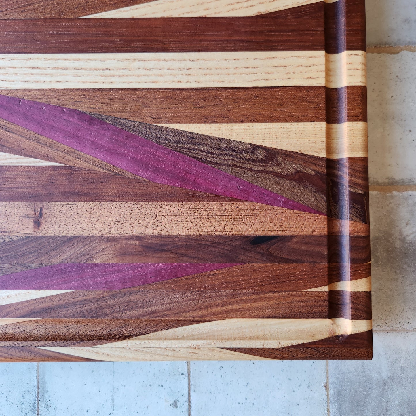 Cutting Board in Purple Heart, Padauk, Black Walnut, Sapele, and Mahogany by Rhino Woodworking