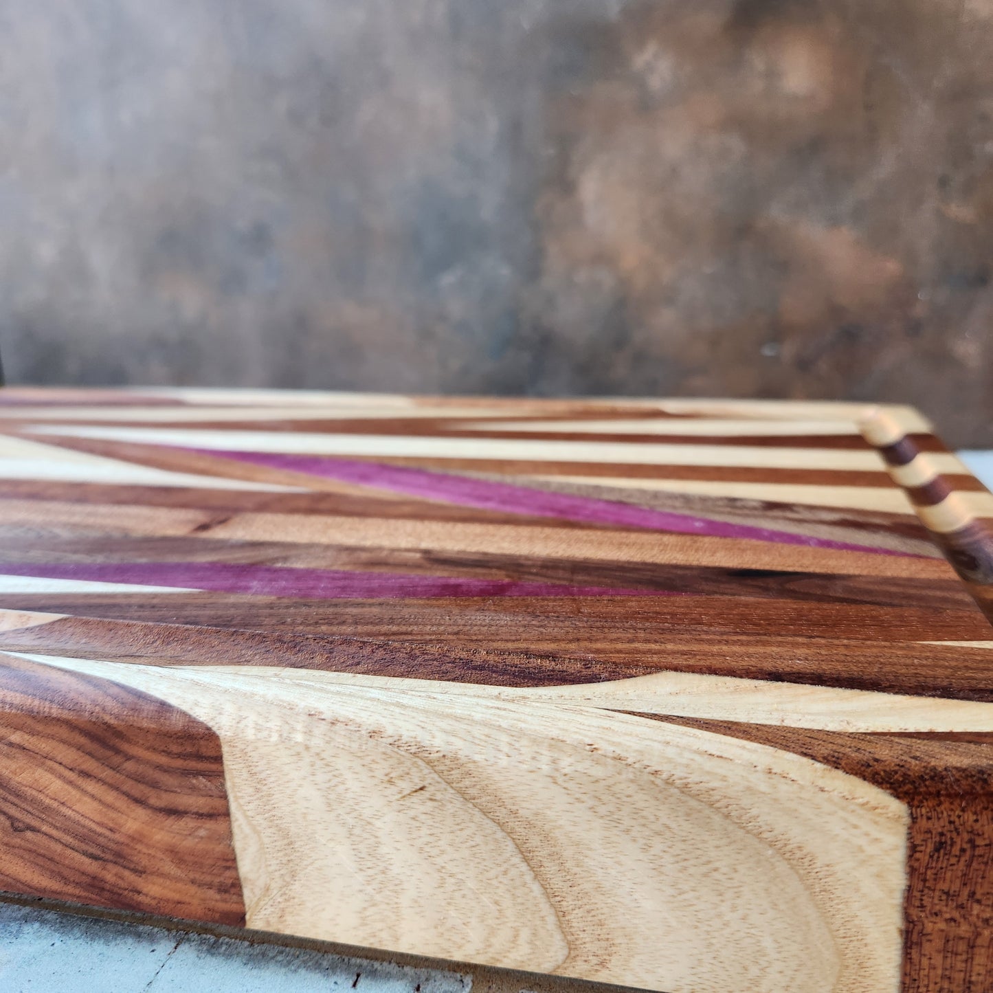 Cutting Board in Purple Heart, Padauk, Black Walnut, Sapele, and Mahogany by Rhino Woodworking